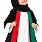 Close-up of the girls' abaya red and green bands over the white inner dress